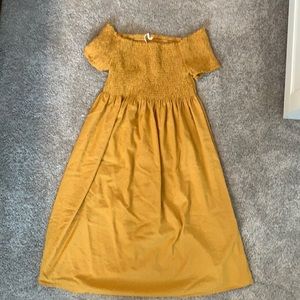 Off the shoulder yellow maternity dress.